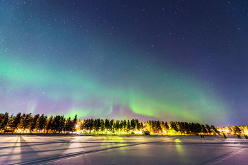 Northern lights over Jokkmokk and the Lake Talvatis, in the heart of Swedish Lapland within the...