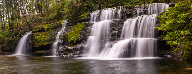 Panoramic view with long exposure shot of waterfall, in the Brecon Beacons, Wales scenic waterfall with flowing water