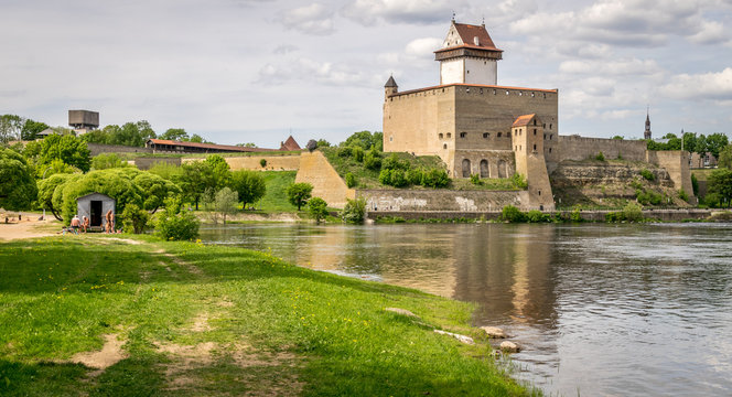 Narva or Hermann castle on a sunny day near the riverbank