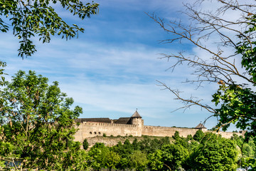 Fototapeta na wymiar Ivangorad castle on a sunny day seen through trees. 