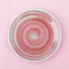Pink ceramic plate on the light background