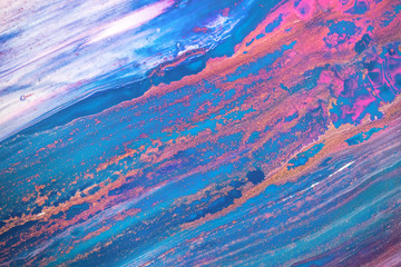 Fototapeta na wymiar Abstract created using the technique of liquid acrylic. Macro photography of the smallest details of a picture. The picture shows how overflows of shades and colors of paint resemble space motifs.