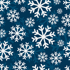 Seamless pattern. White snowflakes on a blue background. Vector drawing. Texture.