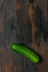 Fresh green cucumber on a old wooden table. Organic food. Top view.