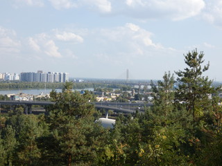 City panorama with a place across the river, park, summer day. View of the city of Kiev, the...