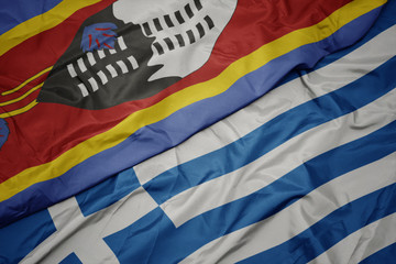 waving colorful flag of greece and national flag of swaziland.