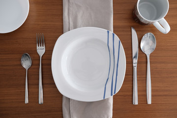 Table set for one diner on a wooden table