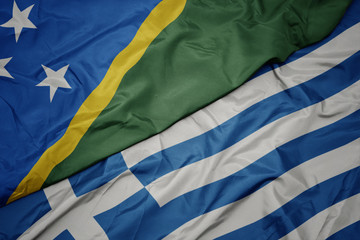 waving colorful flag of greece and national flag of Solomon Islands .