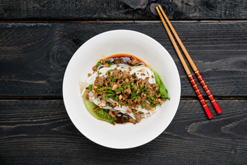 Dan Dan Noodles from above. Dan Dan Noodles is a spicy Szechuan cuisine dish commonly found in chinese street food. Ingredients include thick rice noodles, sichuan pepper, chili oil and ground pork.