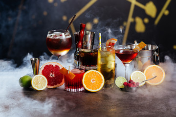 Exotic tasty alcoholic cocktails on dark background