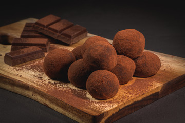 Craft chocolate truffles on wooden board
