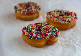 Donuts with white icing and sprinkles