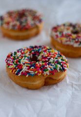 Donuts with white icing and sprinkles