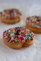 Donuts with white icing and sprinkles