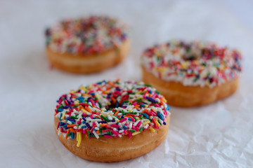 Donuts with white icing and sprinkles