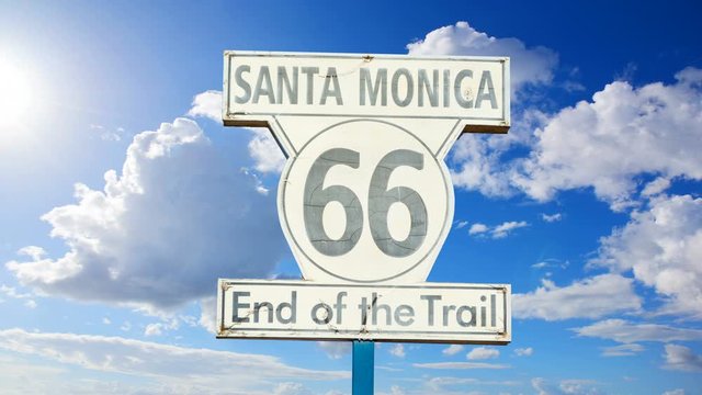Clouds passing over "Route 66 end of the trail" sign in Los Angeles, California.