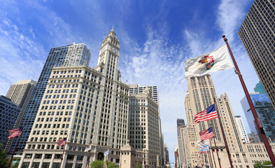 Wrigley Building and Tribune Tower on Michigan Avenue with Illinois flag on the foreground in...