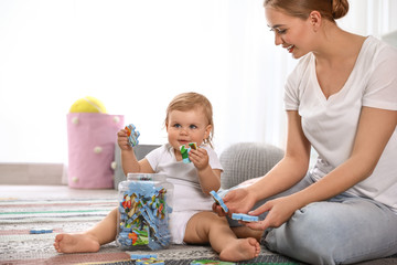 Mother playing with her baby at home