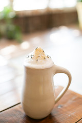 Lavender london fog tea latte with steamed milk and sugar on table in cafe, cafe in background, copy space
