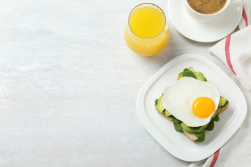 Delicious breakfast with fried egg served on table, flat lay. Space for text