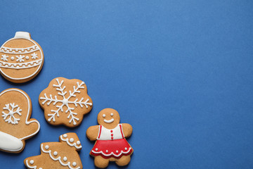 Flat lay composition with tasty homemade Christmas cookies on blue background, space for text