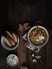Vegetarian fall soup and bread on wooden background. Copy space.