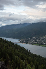 Obraz premium Beautiful View of a small Town, Nelson, during a dark and cloudy sunset. Located in the Interior of British Columbia, Canada.