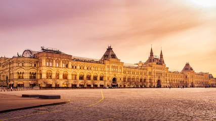 Fototapeta na wymiar Panoramic, wide view at the Red Square and GUM shopping mall with few tourists, early hours and beautiful sunrise, Moscow, Russia