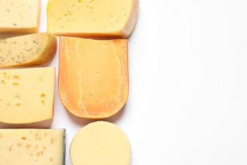 Composition with different kinds of tasty cheese on white background, top view