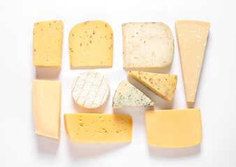 Composition with different kinds of tasty cheese on white background, top view