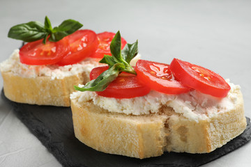 Tasty fresh tomato bruschettas on grey table, closeup