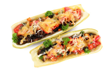 Delicious baked stuffed zucchini on white background, top view