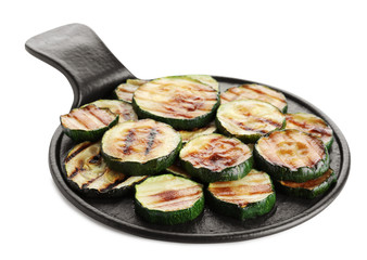 Slate plate of delicious grilled zucchini slices on white background