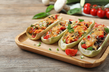 Delicious stuffed zucchini served on wooden table