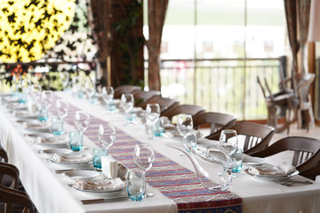 Table set for dining with cutlery, glassware and wine glasses