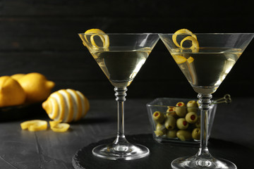 Glasses of Lemon Drop Martini cocktail with zest on grey table