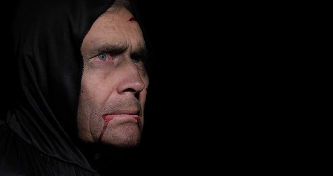 Old executioner Halloween makeup and costume. Elderly man with blood on his face