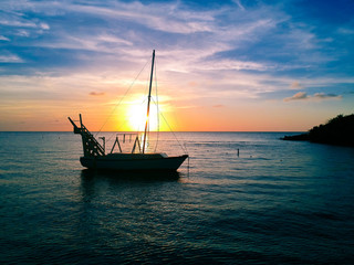 Aerial view of sailboat and awesome sunset in West End, Roatan, Honduras