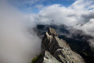 Beautiful View of Canadian Mountain Landscape during a cloudy summer morning. Taken on Crown Mountain, North Vancouver, British Columbia, Canada.