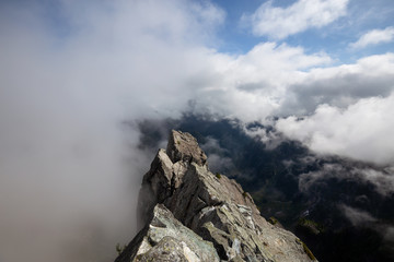 Beautiful View of Canadian Mountain Landscape during a cloudy summer morning. Taken on Crown Mountain, North Vancouver, British Columbia, Canada.