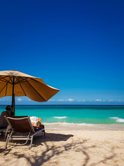 Fototapeta na wymiar Umbrella and chair in a nice beach in Playa blanca, Barú, Colombia