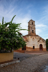 Fototapeta premium Beautiful View of a Church in a small touristic Cuban Town during a vibrant sunny and cloudy evening before sunset. Taken in Trinidad, Cuba.