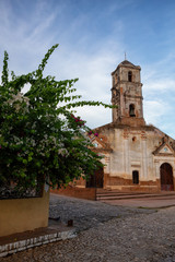 Fototapeta na wymiar Beautiful View of a Church in a small touristic Cuban Town during a vibrant sunny and cloudy evening before sunset. Taken in Trinidad, Cuba.