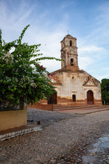 Fototapeta na wymiar Beautiful View of a Church in a small touristic Cuban Town during a vibrant sunny and cloudy evening before sunset. Taken in Trinidad, Cuba.