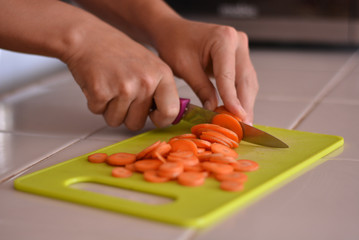 Close-up picture of chopping carrot in the kitchen.