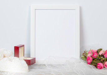 White Frame A4 or letter size mock up for wedding or celebrations anniversary on white table with pink rose, diamond ring, coffee cup decoration and white background