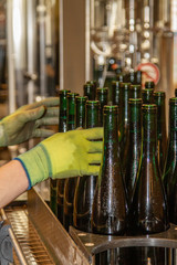 in a winery automatically filled bottles are taken off from the filling station