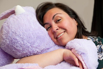 woman snuggling stuffie