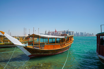 Fototapeta na wymiar Dhow traditional style design moored along Doha Old Town waterfront