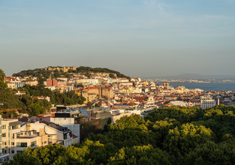 Fototapeta na wymiar Castle and cathedral in downtown Lisbon illuminated by the setting sun